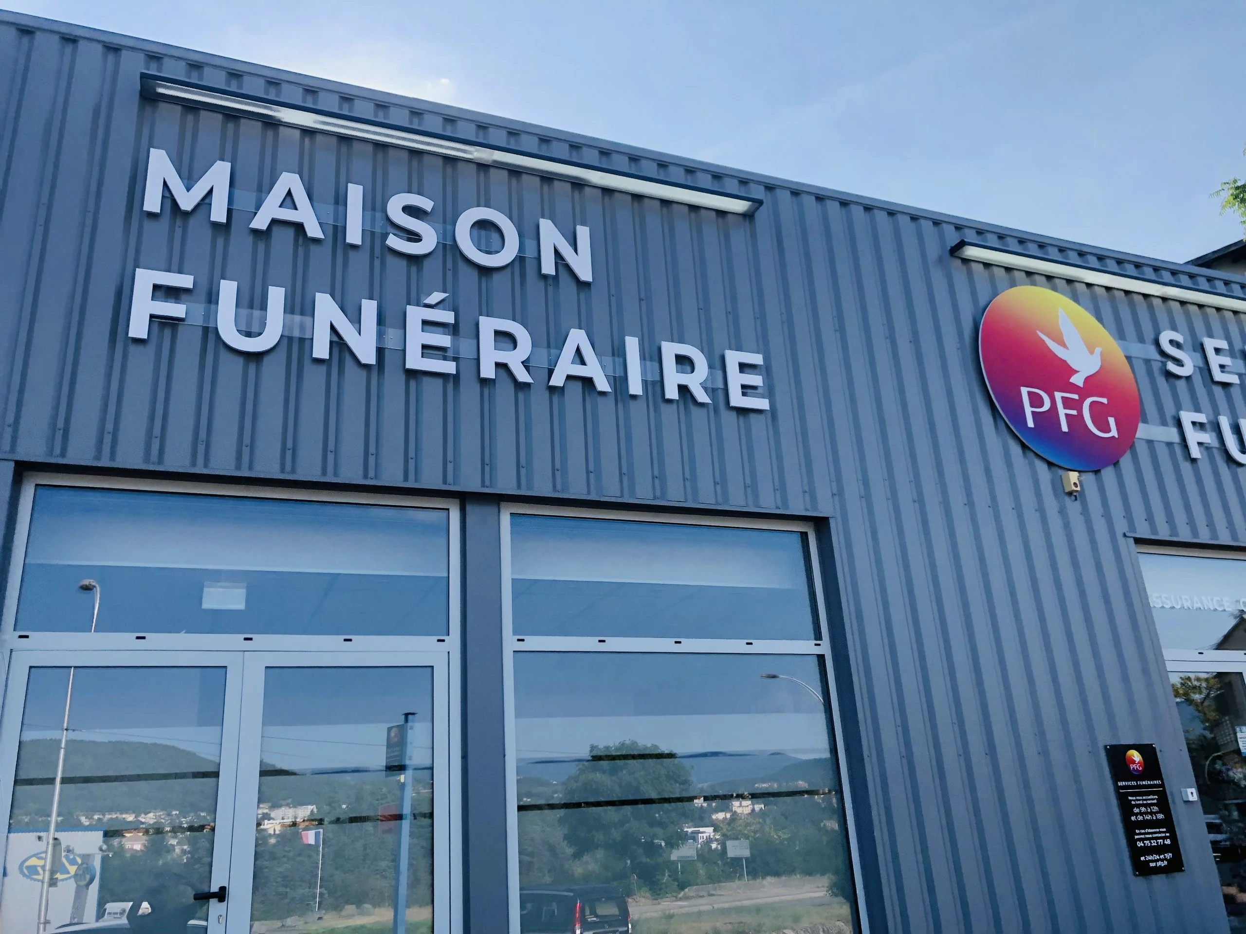 Grandes lettres blanches Maison Funéraire et logo rond PFG sur bardage gris
