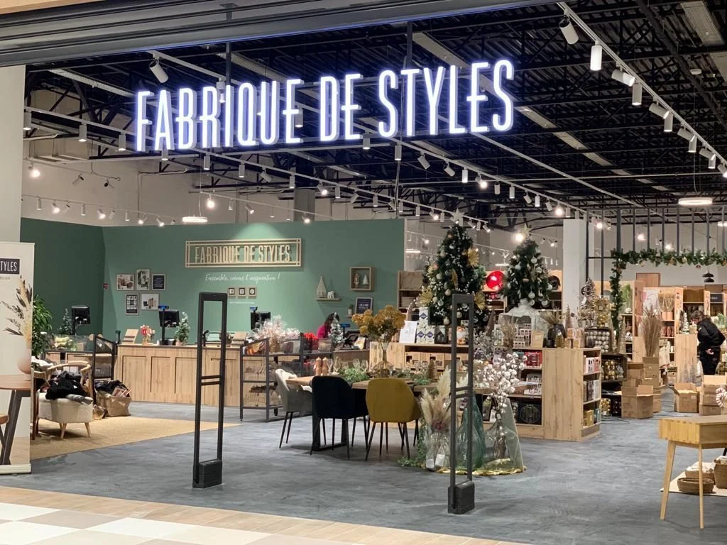 Grand lettrage lumineux Fabrique de Styles suspendu à l’entrée du magasin