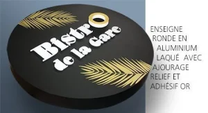 Enseigne ronde noire avec lettres blanches et décor doré en relief
