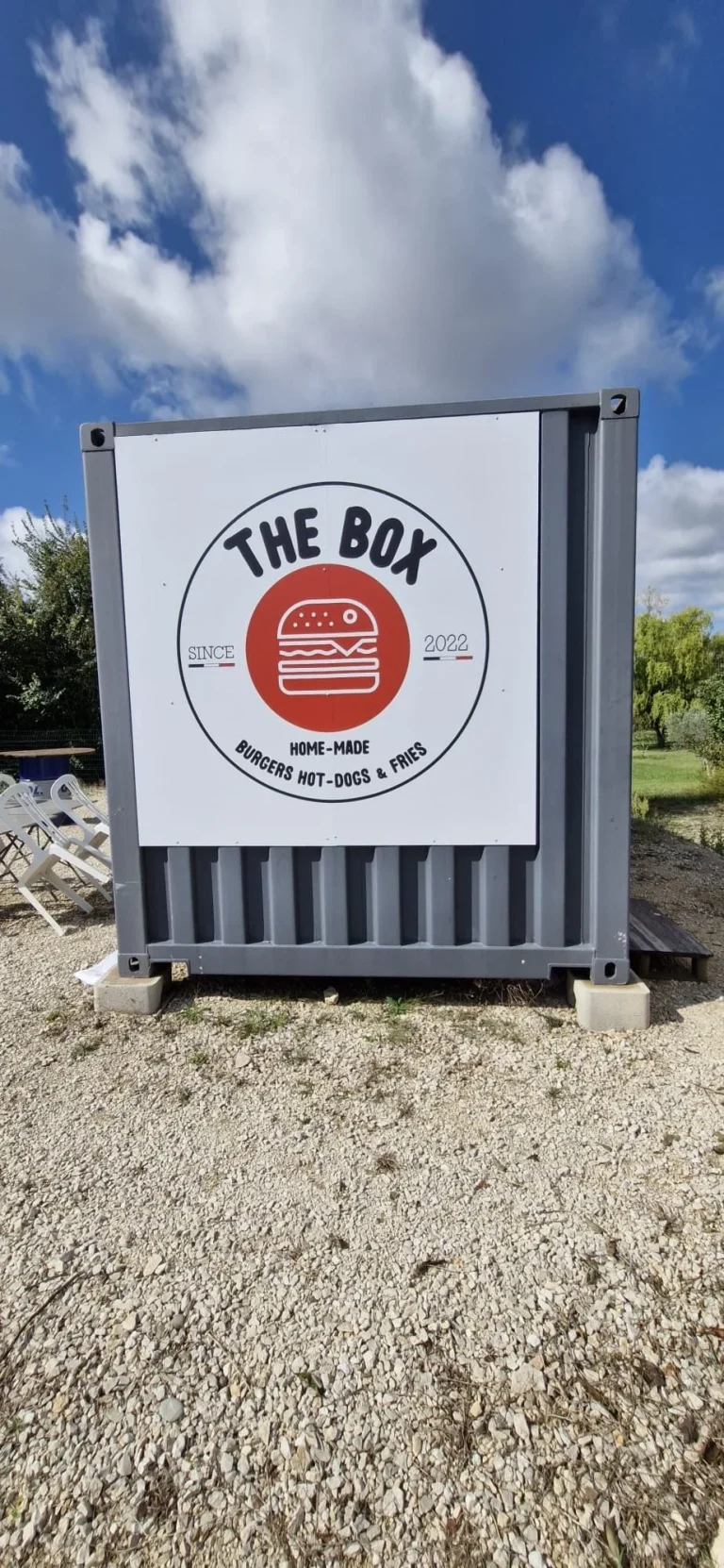 Détail du panneau rond The Box sur conteneur